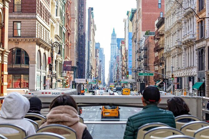 Express Sightseeing Bus Tour with Statue of Liberty Cruise Combo - Midtown Landmarks: Neon, Beaux-Arts Lions, and a Triangular Photo Moment