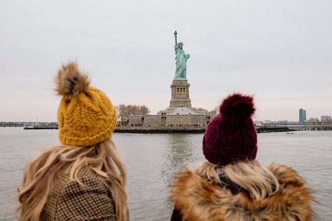 NYC Night Bus Sightseeing Tour with Free Statue of Liberty Cruise - Lower Manhattan Skyline and the Ferry Landmarks: One World Trade to Governors Island